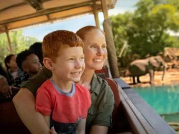 A mum and son looking at elephants on Kilimanjaro Safaris