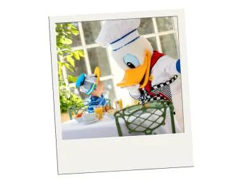 A polaroid of a child meeting Donald Duck in a chef outfit