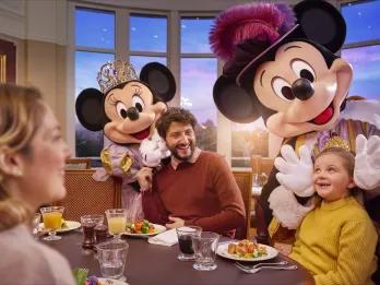 A family meeting Mickey and Minnie dressed as royalty at Royal Banquet