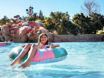A young girl on a float in a wave pool