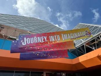 A sign for a theme park ride called Journey into Imagination with Figment