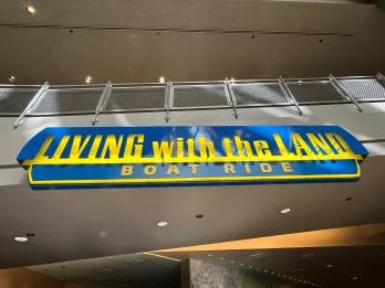 A sign for a theme park ride called Living with the Land