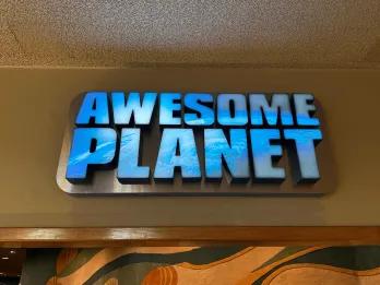 A sign for a theme park attraction called Awesome Planet