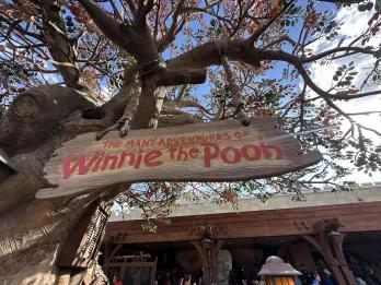 A sign outside a theme park attraction called The Many Adventures of Winnie the Pooh