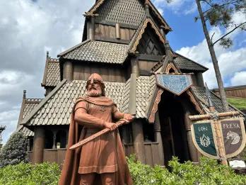 A statue of a Viking solder in front of a Norwegian building