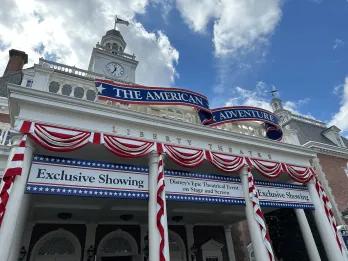 A building decorated with red, white and blue ribbons and signs