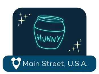 An outline of a honey pot labelled 'Hunny' above a location label for Main Street USA