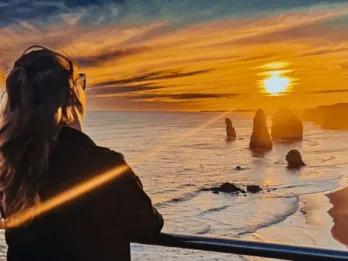Sunset view over the ocean with tourist enjoying the moment on Great Ocean Road