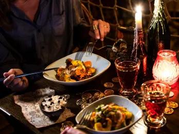 Two people eating at a restaurant table themed after Pirates of the Caribbean