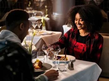 Two adults eating at a fine dining restaurant