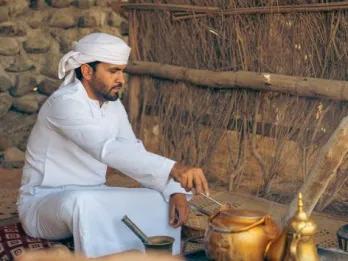 Man performing live traditional Emirati cooking