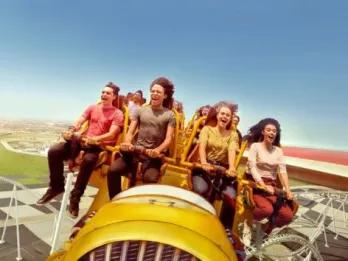 People having fun riding Flying Faces at Ferrari World Yas Island