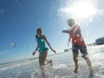 Two kids playing and splashing in the ocean waves at Daytona Beach.