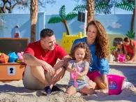 Family playing in the sand pit at Peppa Pig Theme Park