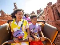 A boy and woman riding a rollercoaster