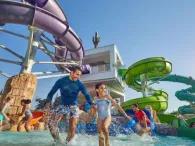 Father and daughters running through Splashers Cove at Atlantis Dubai Aquaventure Waterpark