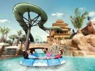 Excited riders on Zoomerango slide at Atlantis Aquaventure Waterpark