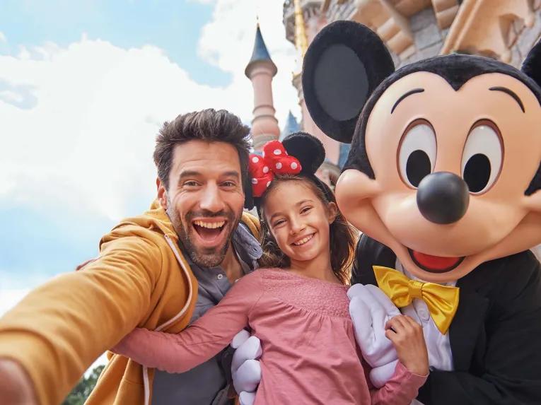 Family with Mickey in front of Sleeping Beauty Castle at Disneyland Paris