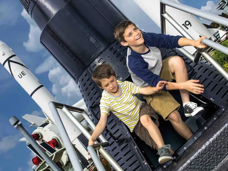 Boys playing in the Rocket Garden at Kennedy Space Center