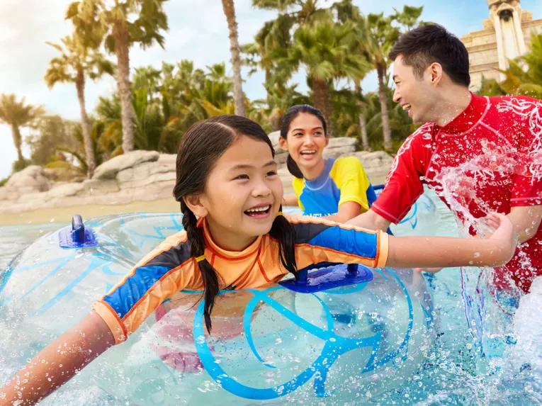 Family playing on the lazy river at Aquaventure Dubai