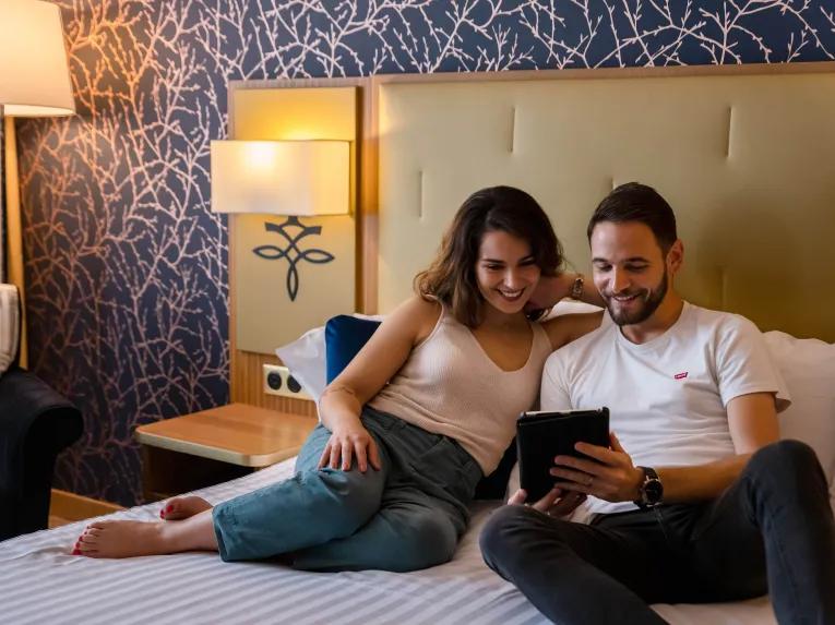 Couple in a standard room at the Dream Castle Hotel Paris