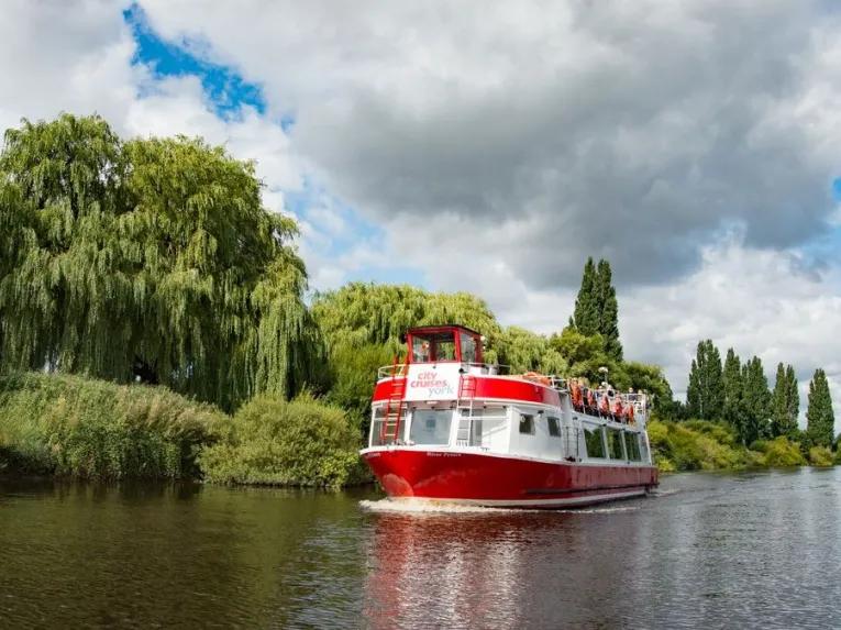 boat-going-past-riverbank