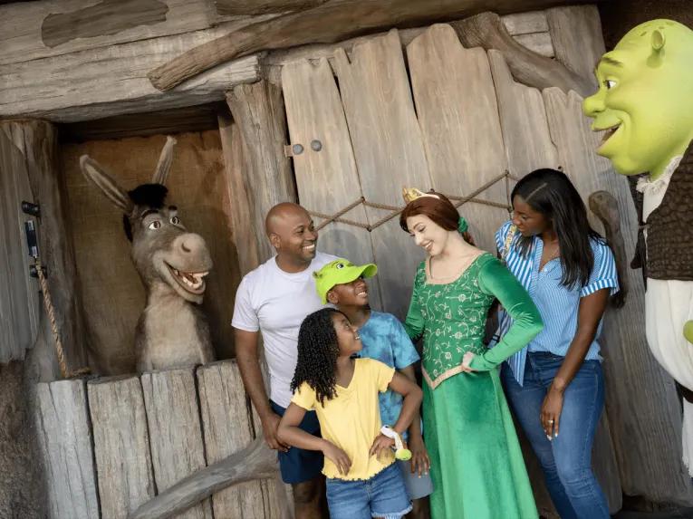 A family meeting Shrek, Fiona and Donkey in DreamWorks Land