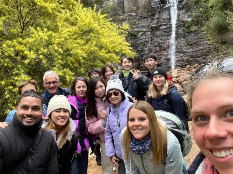 Group of people smiling at Silverband Falls
