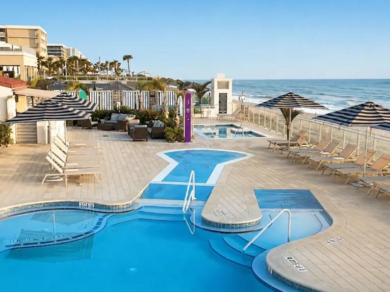 Hard Rock oceanfront pool deck and sun lounge chairs with direct views of the beach