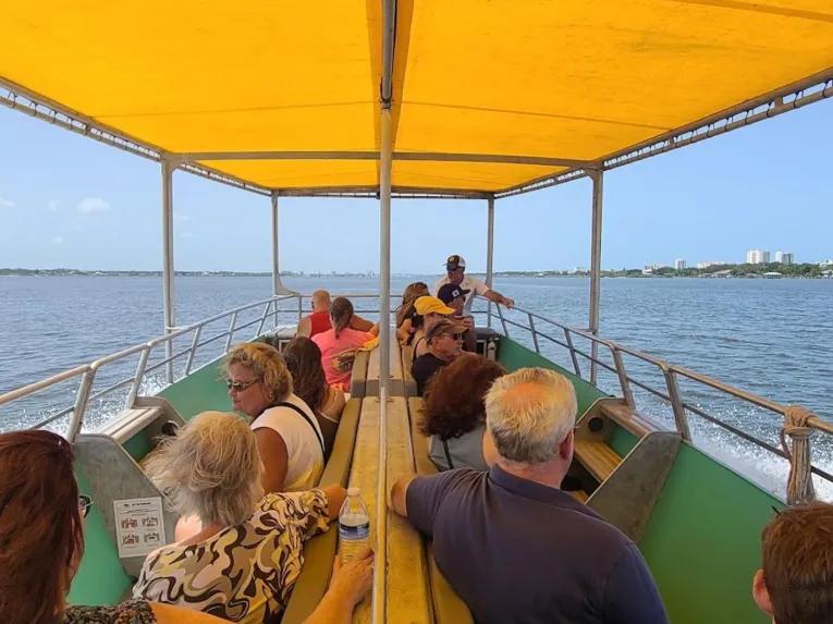 Tourists on a covered boat tour cruising the coastal waters of Daytona