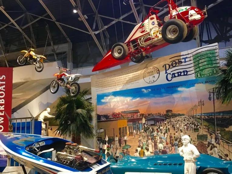 Racing exhibits and historic vehicle displays at Daytona International Speedway.